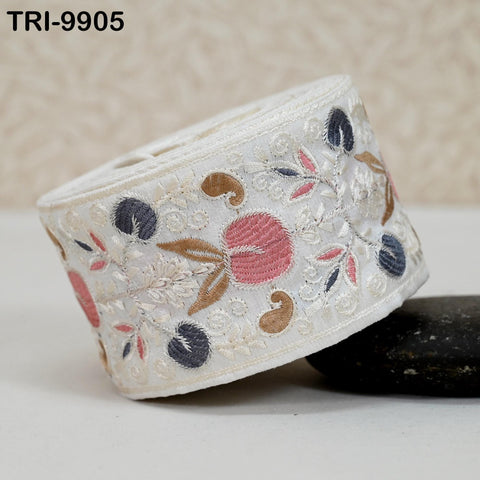 A decorative fabric with a floral pattern, featuring a mix of pink, blue, and brown colors, is shown in the image.