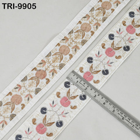 a decorative fabric with a floral pattern, and a ruler is placed on top of it, indicating the size or dimensions of the fabric.