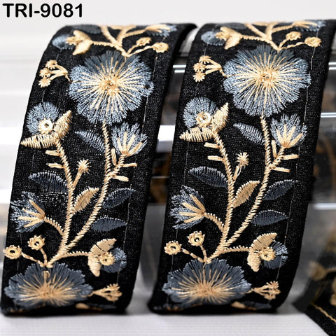 two black and gold embroidered fabric pieces with intricate floral designs.