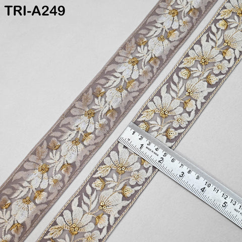 a decorative fabric with a floral pattern, and a ruler is placed on top of it to measure the length of the fabric.
