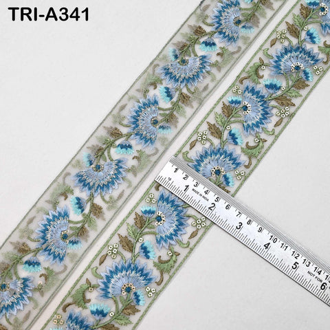 a decorative fabric with a floral pattern, and a ruler is placed on top of it to measure the length of the fabric.