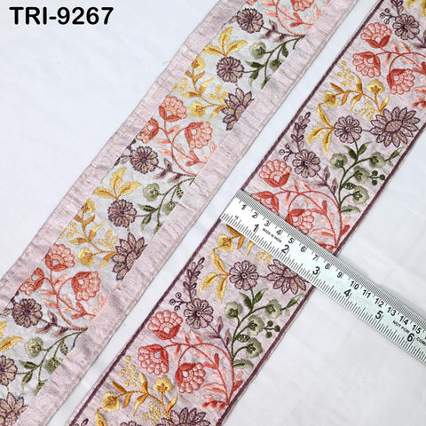 two pieces of fabric with a floral pattern, one on the left and one on the right. A ruler is placed between the two pieces of fabric, indicating their size.