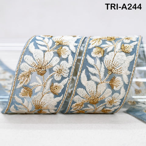 a decorative blue and white fabric with intricate floral embroidery.