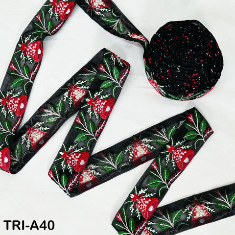 a spool of red and black embroidered ribbon, along with a spool of black and red embroidered ribbon, both featuring a floral pattern.