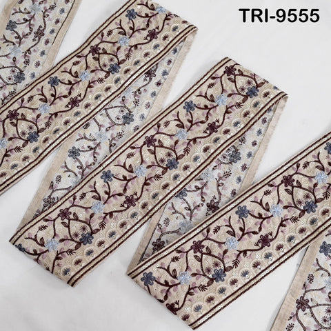 a collection of decorative fabric pieces with a floral pattern. The fabric appears to be a beige color with a repeating pattern of flowers and leaves. The fabric pieces are arranged in a row, with the leftmost piece being the closest to the viewer.