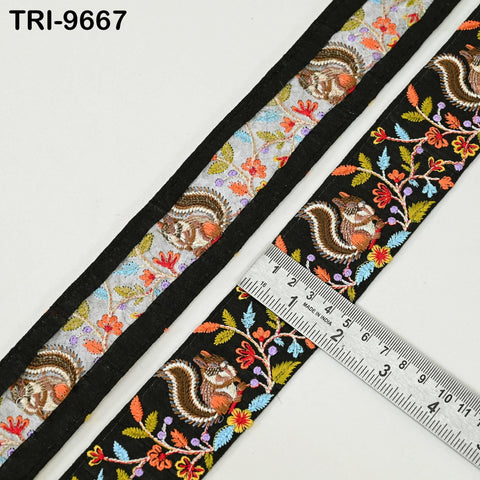 a decorative fabric with a floral pattern and a ruler placed on top of it, indicating the size of the fabric.