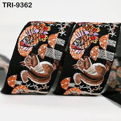 two decorative fabric items with a floral pattern. The items are black in color and have a vibrant, colorful design with various shapes and patterns, including butterflies and leaves.