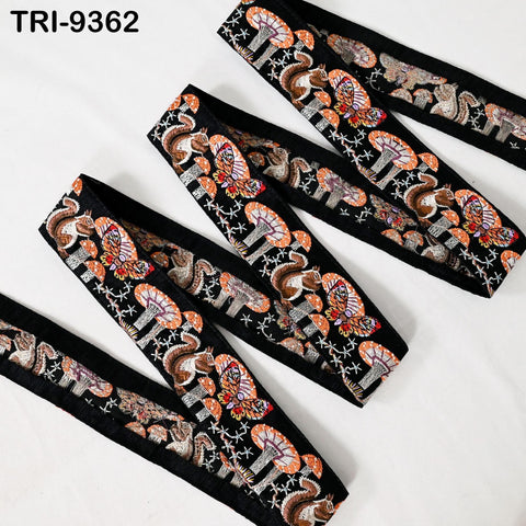 a collection of decorative fabric pieces with a repeating pattern of mushrooms and stars on a black background.