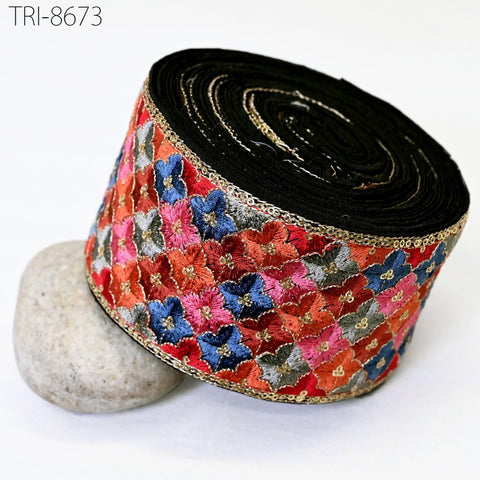 A decorative black and gold ribbon with a floral pattern is shown in the image.