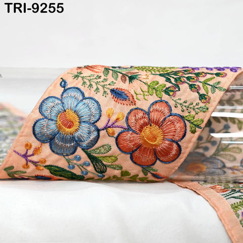a close-up view of a decorative fabric with a floral pattern. The fabric is adorned with vibrant colors and intricate embroidery, creating a visually appealing and detailed design.