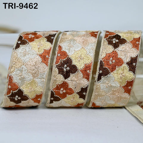 three decorative fabric pieces with a floral pattern in shades of brown, beige, and orange.