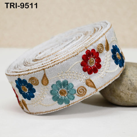 A decorative fabric with a floral pattern in white, blue, and red colors.