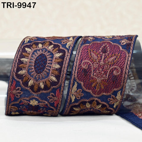 two decorative fabric pieces with intricate embroidered patterns in shades of blue and red.