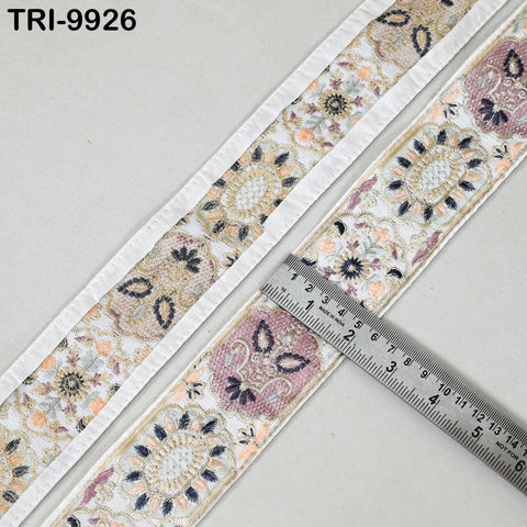 a decorative fabric with a floral pattern, and a ruler is placed on top of it to measure the length of the fabric.