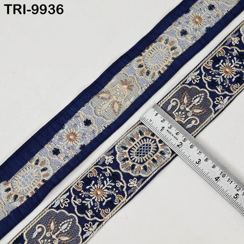 a close-up view of a decorative blue and white fabric with intricate floral patterns. A ruler is placed on the fabric, indicating its size.