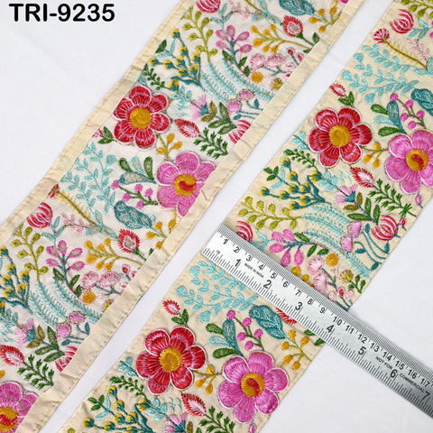 a close-up view of a decorative fabric with a floral pattern, featuring a ruler for scale.