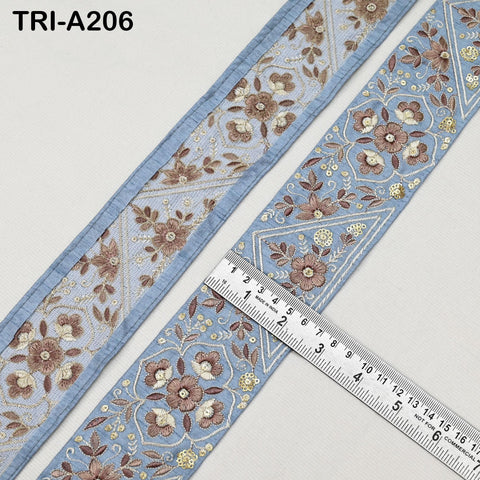 a close-up view of a decorative fabric with a floral pattern, featuring a ruler for scale.
