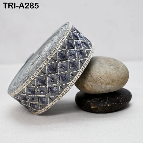 a decorative fabric with a floral pattern, placed on top of two rocks.
