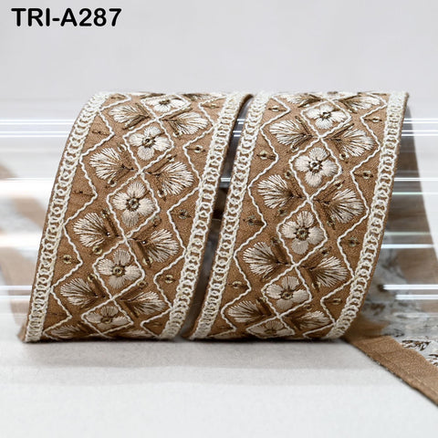 a decorative brown and white fabric with a floral pattern, placed on a white surface.