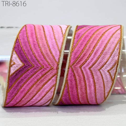 two decorative fabric pieces with a pink and gold striped pattern, placed side by side on a white surface.