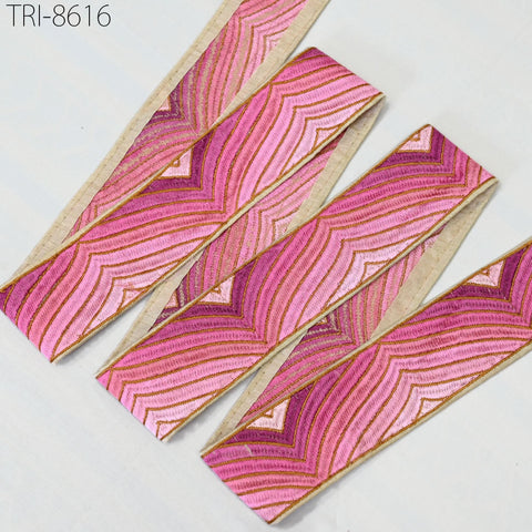 a collection of pink and purple fabric strips arranged on a white background.