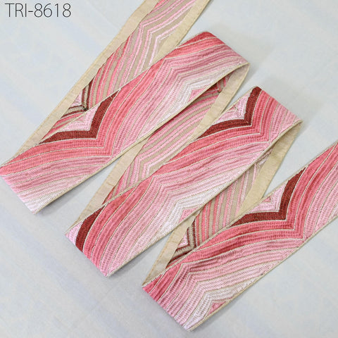 a collection of pink and beige striped fabric pieces arranged on a white background.