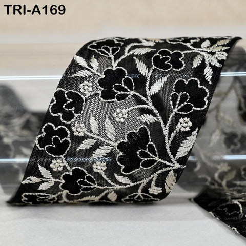 a close-up view of a black and white floral lace ribbon.