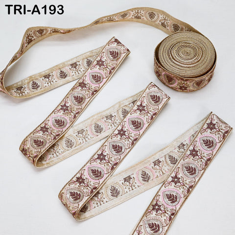a collection of decorative fabric ribbons with a floral pattern, including a large roll of the same ribbons and several individual pieces.