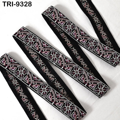 a collection of decorative fabric pieces, including a black and white patterned fabric with a floral design. The fabric appears to be a decorative trim or embellishment, possibly used for clothing or home decor.