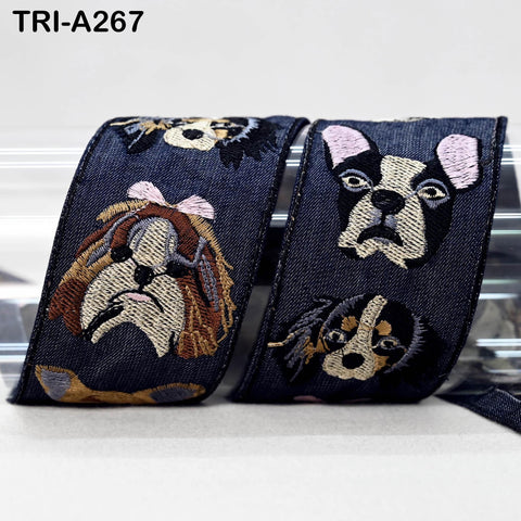 a pair of blue ribbons with embroidered dog faces on them.