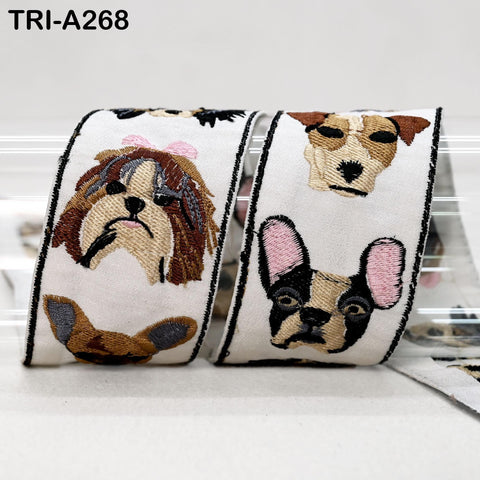 two rolls of ribbon with embroidered dog faces on them.