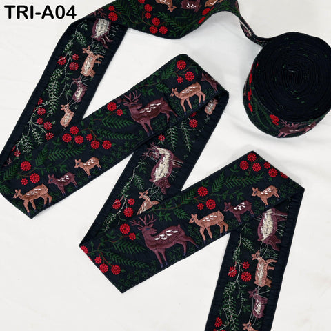 a decorative fabric with a floral pattern and various animal motifs, including deer, birds, and flowers, arranged in a zigzag pattern.