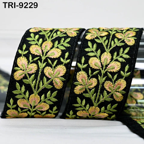 two decorative fabric pieces with a floral pattern in black and green colors. The pieces appear to be made of a material that resembles lace or fabric with a floral design.