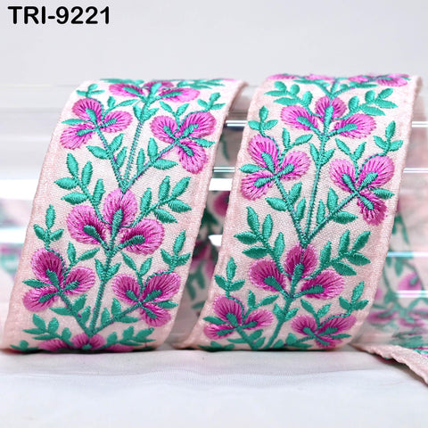 a decorative ribbon with a floral pattern in shades of pink and green.