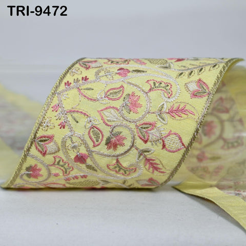 a close-up view of a decorative yellow fabric with a floral pattern.