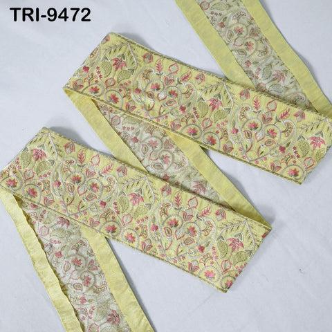 a decorative fabric with a floral pattern in shades of yellow and green. The fabric appears to be a decorative trim or border, possibly used for embellishing clothing or other textile items.
