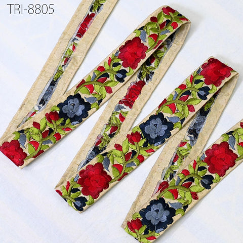 a collection of colorful, embroidered fabric pieces arranged on a white background.