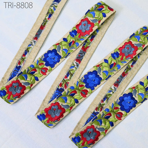 a collection of colorful, embroidered fabric pieces arranged on a white background.