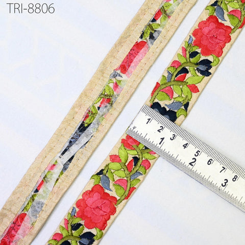 a close-up view of a decorative fabric with a floral pattern, featuring a ruler for scale.