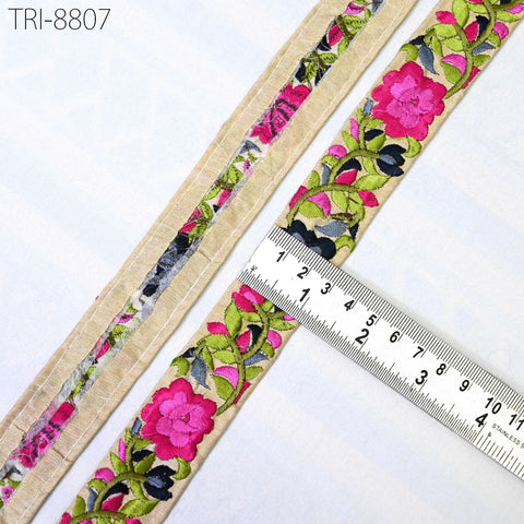 a close-up view of a decorative fabric with a floral pattern, featuring a ruler for scale.