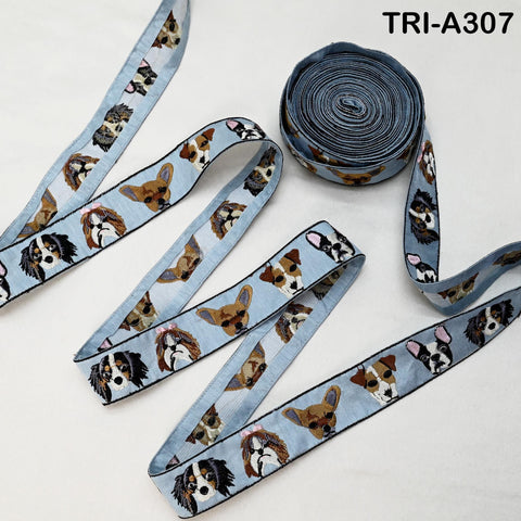 a collection of dog-themed ribbons and a spool of thread, all arranged on a white surface.