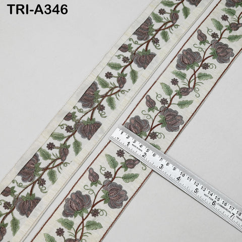 a decorative border with floral patterns and a ruler placed next to it, indicating the size of the border.