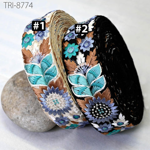 two decorative fabric items with floral patterns, one in black and one in white, placed on a white surface.