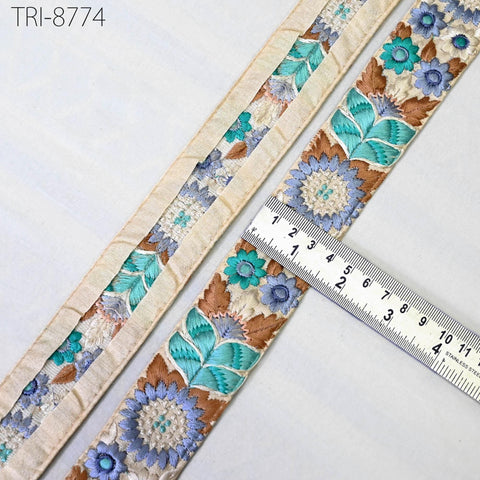 a close-up view of a decorative fabric with a floral pattern, featuring a ruler for scale.