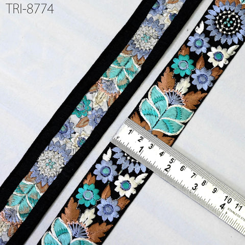 a close-up view of a decorative fabric with a floral pattern, featuring a ruler for scale.