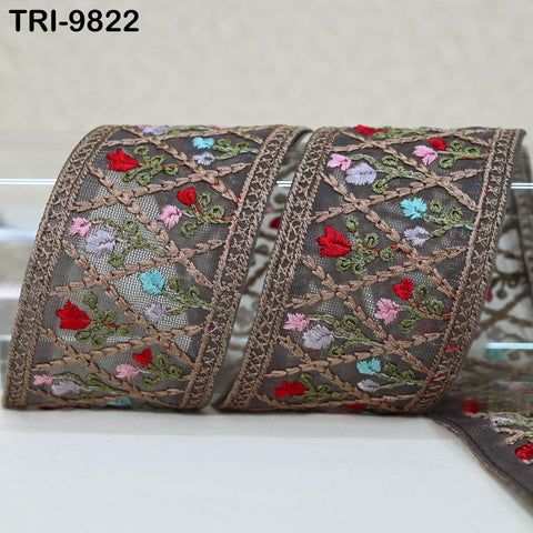 two decorative fabric pieces with intricate floral embroidery in shades of brown, pink, and green. The pieces are arranged side by side, creating a visually appealing display.