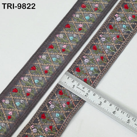two pieces of decorative fabric with a floral pattern, lying on a white surface. A ruler is placed next to the fabric, indicating the size of the fabric.