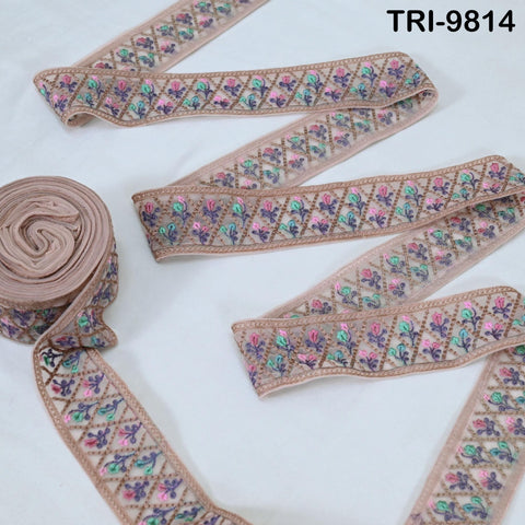 a collection of decorative fabric pieces, including a spool of fabric with a floral pattern and several pieces of fabric with a similar floral design.