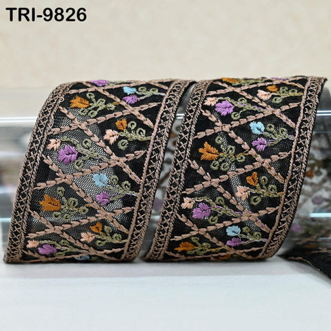 two decorative fabric pieces with intricate floral embroidery. The pieces are black with a gold border, and the embroidery features a variety of colorful flowers and leaves.