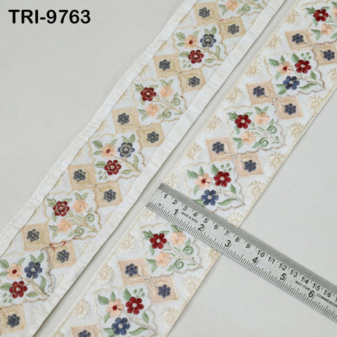 two pieces of fabric with a floral pattern, and a ruler is placed between them, indicating the size of the fabric.